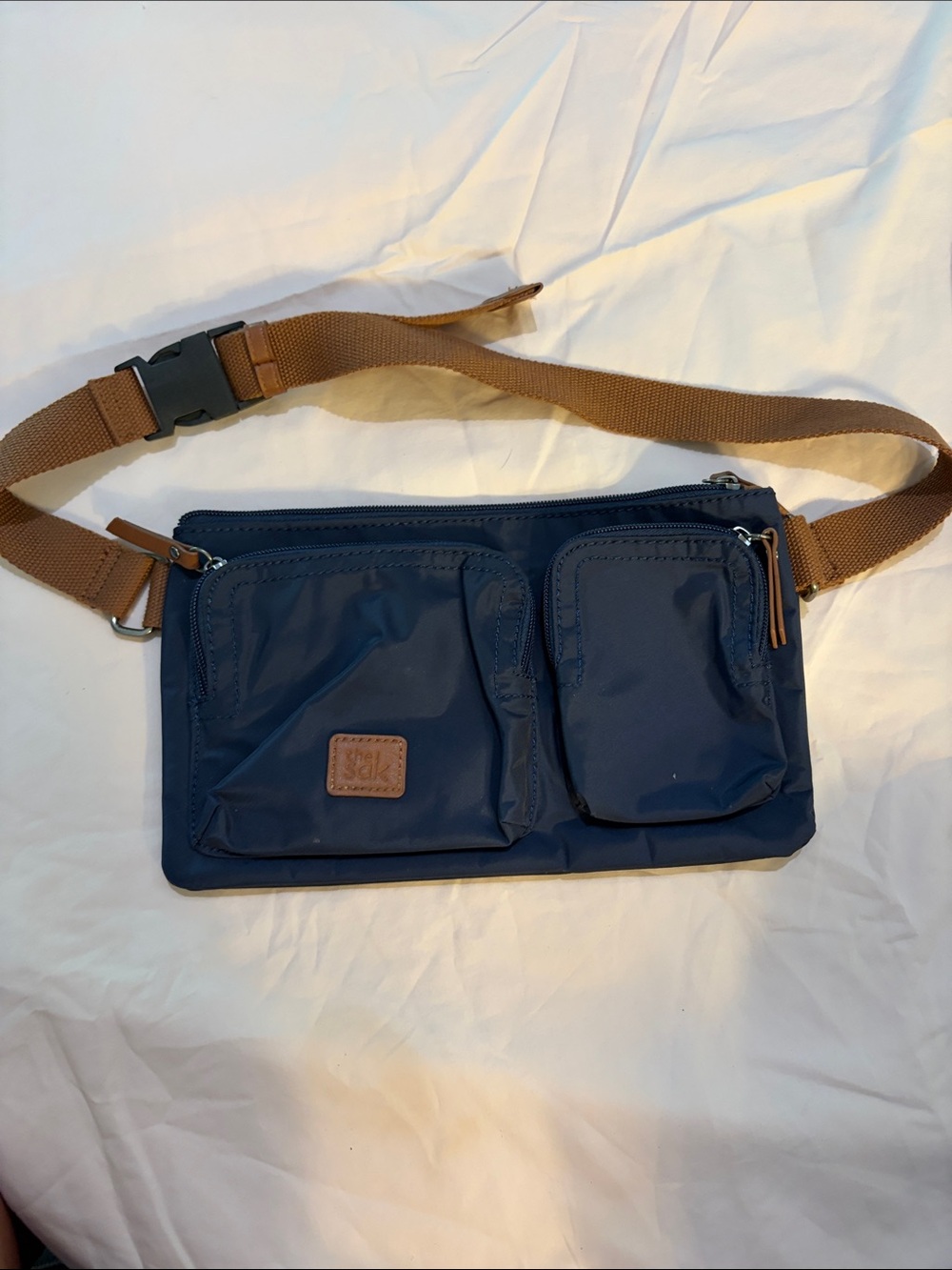 The Sak Navy Belt Bag with Brown Strap